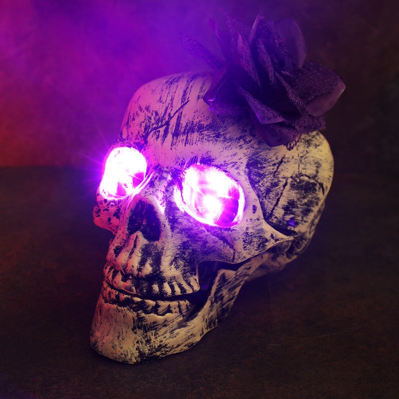 Purple Eye Head Flower Halloween LED skull decoration with glowing purple eyes and flower accent