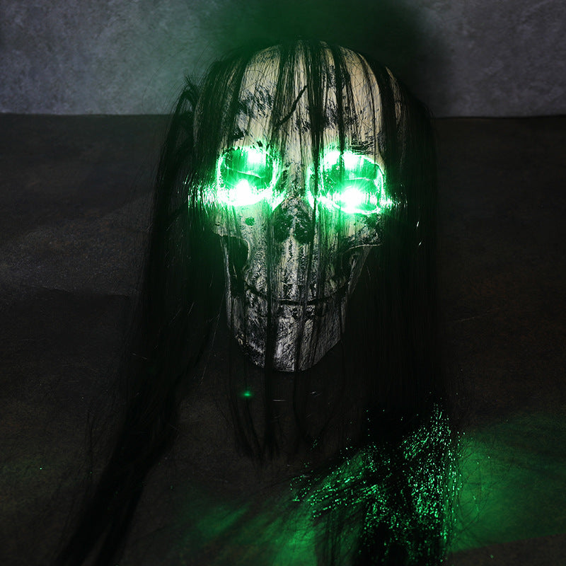 Green Skull With Hair Halloween LED decoration with glowing green eyes and dark hair strands