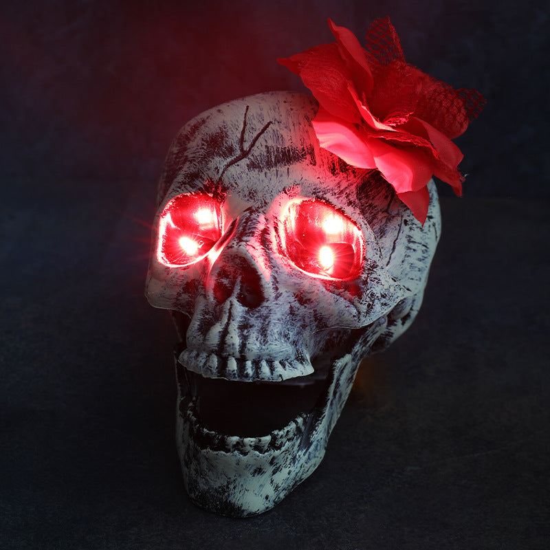 Red Eye Head Flower Halloween LED skull decoration with glowing red eyes and red flower accent